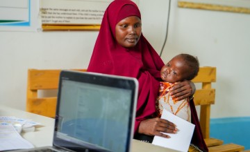 Ayan with Mohamed inside the Siinkadheer Health Facility, operated by Concern and funded by the European Union. Photo: Adnan Mohamed/Concern Worldwide