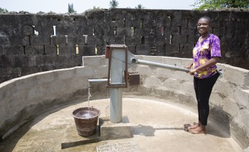 Patience Jackson of the local WASH committee at a newly constructed water point in Joe Quarter, Buchanan. The construction and rehabilitation of wells across multiple urban communities around Buchanan has been supported by the Bertin Family Foundation. Photo: Kieran McConville/Concern Worldwide