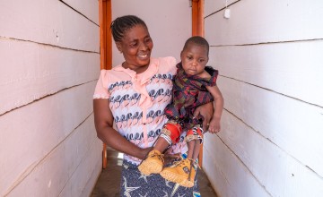 Francine Kavira Vake is caring for her granddaughter Christivie, who has difficulties sitting independently, walking and talking. Photo: Eugene Ikua/Concern Worldwide