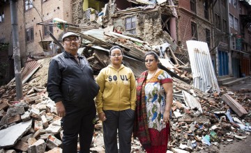 Swenchya Tamrakar, with her parents Padam Bahaduj and Dayalumni, in front of what remained of their home in Lalitpur, Kathmandu, April 2015. (Photo: Crystal Wells/Concern Worldwide)