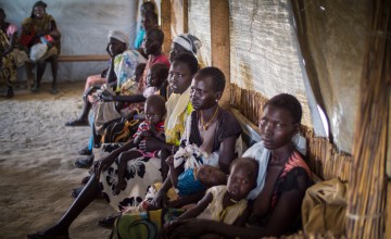 Women wait with their children for treatment at one of the Concern nutrition centres in Bentiu Protection of Civilians (POC) site in Unity State, South Sudan. Photograph taken by: Kieran McConville/Concern Worldwide.