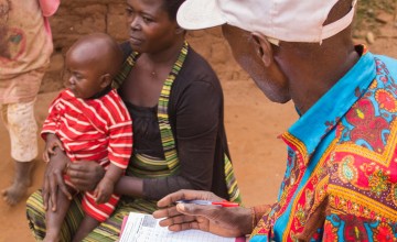 Elisa and her daughter Josephine being screened by a community health worker in Cibitoke. Photo: Irenee Nduwayezu/Concern Worldwide.