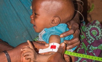 Emeline Niyonkuru a community health worker screening 6 month old Ghislaine who is severely malnourished in Cibitoke. Photo: Irenee Nduwayezu/Concern Worldwide.
