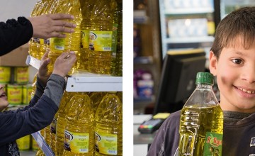Firas helps his mother Mais Ahmadi shop for supplies using the e-vouchers they received from Concern. Photo: Kevin Carroll/Concern Worldwide.