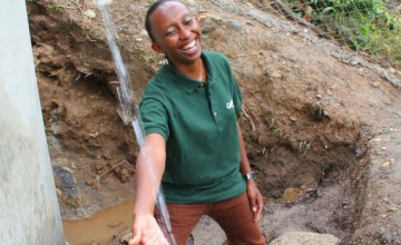 Gloria Kafuria, Concern Worldwide water and sanitation engineer, at a solar water system that she designed in Tanzania. Photo taken by Crystal Wells/Concern Worldwide.