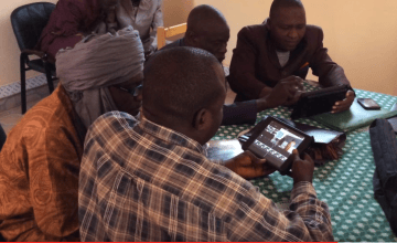 Trainers review footage in order to identify positive examples of teaching methods that they can use to educate teachers in the field. Photograph taken by: Concern Worldwide.