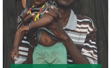 Alex Ali holds his six month old son Elema in a village near Marsabit in Northern Kenya. Thanks to the support that Alex and his family have been receiving, his family are no longer hungry. Photo: Helen Dunne / Concern Worldwide.