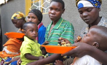 Children are fed as part of a community-based management of acute malnutrition (CMAM) programme held at a community health center in the southern Rwandan village of Gisagara. Photo: Cheney Orr / Concern Worldwide.