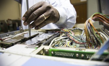 Engineers at Kenyatta Hospital in Nairobi work to repair broken medical equipment. Photo: Concern Worldwide. 