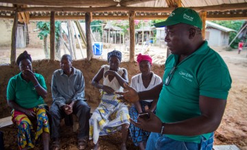Anthony Vandy of Concern talking to community members in the village of Dokoizia in Lofa County, Liberia. Photograph taken by: Kieran McConvillle/Concern Worldwide.