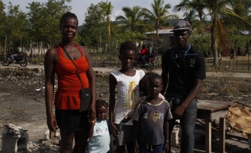 The François family, standing among the rubble of what used to be their home. They evacuated during the hurricane in 2016. Photo: Kristin Myers/Concern Worldwide