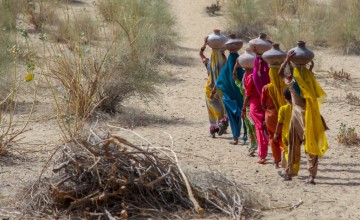 Community women carrying water in mud pots from the communal well in Pakistan, 2007. Photo: Sharjeel Arif/Black Box Sounds.