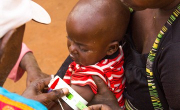 Elisa and her daughter Josephine being screened by a community health worker in Cibitoke. Photo: Irenee Nduwayezu/Concern Worldwide.