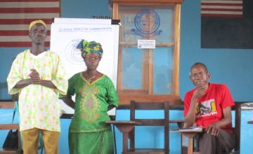 William Zoe, Martha Waaloe, community change makers and Harry Johnson, Concern staff member, at an engaging men and women in equality workshop, Liberia, 2013. Photo: Bernadette Crawford/ Concern Worldwide.