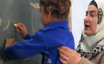 A Syrian refugee child in one of Concern’s makeshift tent classrooms. Photo: Concern Worldwide.