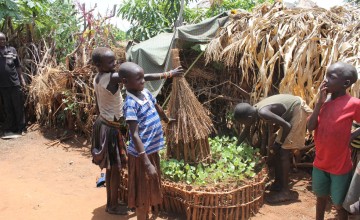 Young children proudly display the keyhole garden they established to help a mother who had just delivered twins. Napak District, Uganda. Photo: Lauren Rogers-Bell/Concern Worldwide.
