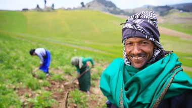 Ethiopian farmer with his daughters working their potato crops in the highlands of South Wollo