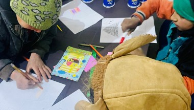 Children do art at a non-formal education (NFE) school in Northern Syria