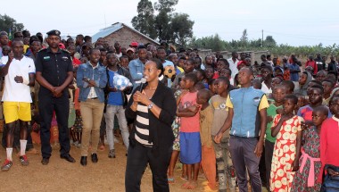 Denise Dusabe, Vice Mayor of Social Affairs in Gisagara district, presents at an HIV/AIDS prevention and family planning event organized by Concern Rwanda. Five local teams participated in a soccer championship, with government representatives presenting both speeches and prizes. Local health center staff also offered voluntary HIV testing, distributed free condoms, and helped couples with selecting appropriate family planning methods.