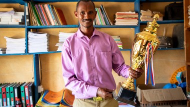 Mr. Boru Ali holds up a trophy won by his students from Bubisa Junior Secondary School at the 2023 Science Fair in Marsabit County. Photo: Eugene Ikua/Concern Worldwide