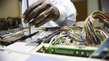 Engineers at Kenyatta Hospital in Nairobi work to repair broken medical equipment. Photo: Concern Worldwide. 