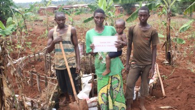 Odette Kanziza, along with family members, stands on front of her kitchen garden which was constructed with thanks to a generous $100 (€95) public donation. Photo: Concern Worldwide.