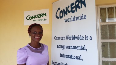 Mabrat Abdulai, Learning and Knowledge Management outside Concern’s office in Tonkolili. Photo credit: Carlos Velazquez.