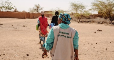 Three women walking in Niger with backs to camera