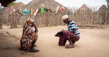 Hussein Mohamed (R), a community health volunteer, does a routine visit to Fatuma Adhan’s (L) house in Handaraku village in Tana River County, where she recently built a toilet. Photo: Lisa Murray/Zurich/Concern Worldwide