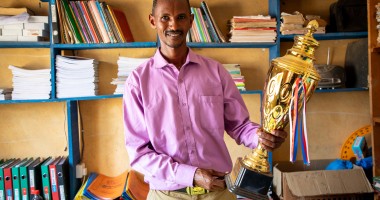 Mr. Boru Ali holds up a trophy won by his students from Bubisa Junior Secondary School at the 2023 Science Fair in Marsabit County. Photo: Eugene Ikua/Concern Worldwide