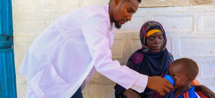 Ahmed Sahane Mohammed, nutritionist at West Imi Health centre provides supplementary food to Tadalesh who had just been diagnosed with malnutrition. 