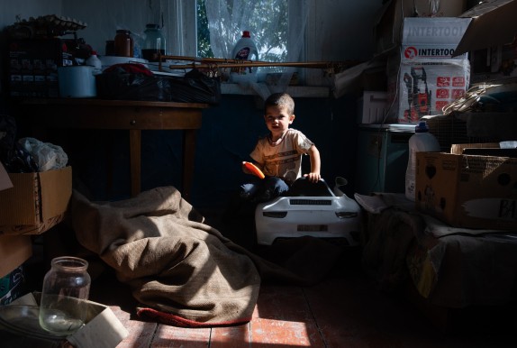 Lesya's three-year-old son inside the relative's house they have moved to after fleeing their home close to the Russian border