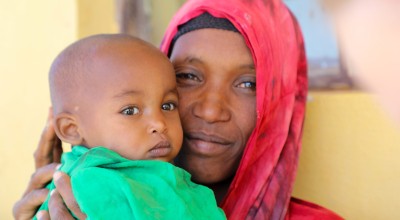 Khayro holds her baby daughter, Halimo, who is healthy and happy again after receiving emergency therapeutic food from Concern. Photo: Jennifer Nolan / Concern Worldwide