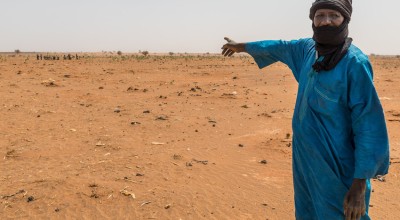 Mahamadou Islam Garmaz, Chief of Garmazaye village, points to the arid landscape