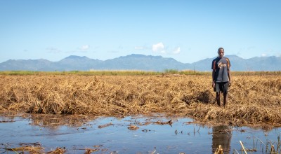 Patrick Ghembo of Monyo Village, Malawi, standing in his field, destroyed by floods. Photo: Concern Worldwide.