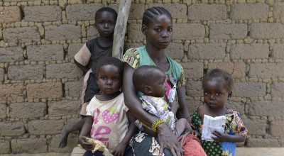 Golden Marlenue, 27 outside her home with her young children. Her two youngest children Naomi, two and Athanase, 12 months, are both malnourished. Photo: Chris de Bode/Panos Pictures for Concern Worldwide