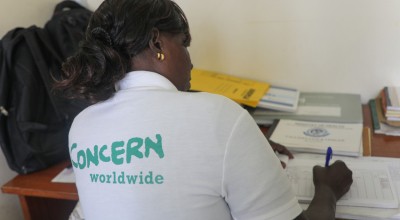 Community Health Volunteer Isabelle writing up her notes in Mukuru Health Centre in Kenya. Photo: Jennifer Nolan / Concern Worldwide.