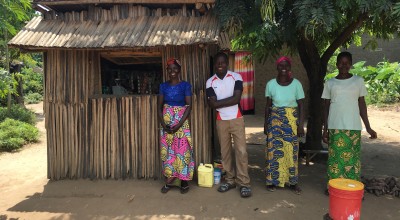 Graduation beneficiaries in front of the shop they have set up under the project; they have taken the initiative to establish a hand-washing station in front of the shop and they report soap sales have increased in the last few days as communities have been sensitised on the importance of hand-washing to prevent COVID transmission. Burundi Photo: Maud Biton / Concern Worldwide