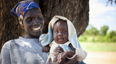 Agel* (39) with Kuek* (3 months), she is a member of The Majok Mother Care Group ina a rural area of Aweil, South Sudan. Photo: Abbie Trayler-Smith / Concern Worldwide