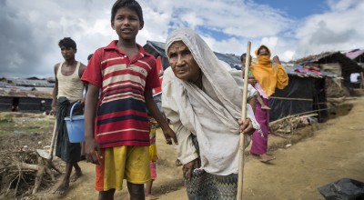 A young Rohingya boy and his grandmother in a refugee camp