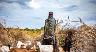 Ng’ikario Ekiru with the last of her goat herd outside their home in Turkana, northern Kenya. She is feeding her family with wild desert fruit and roasted animal hides as the area experiences the second drought in three years.
