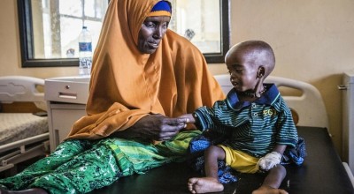 The caption reads: Halima (50) and her grandson Aaden (3) in Banadir Maternity & Children Hospital, Mogadishu, Somalia. Aaden’s mother is dead and Halima brought him from their home 120km outside the city where all 40 of their cattle have died and only a few goats and camels remain. Photo: Ed Ram/Concern Worldwide
