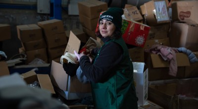 Woman with emergency relief items for earthquake affected communities