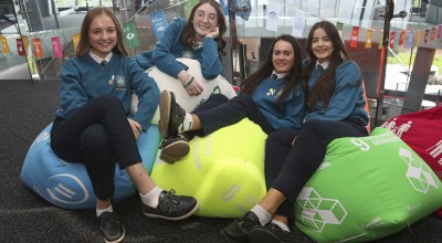 Female students on debate team sit on colourful beanbags