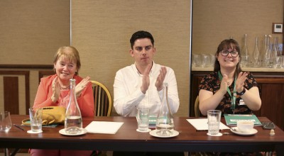 Adjudicators, Bernadette Brennan, Cathal Curry, and Lauren Wright clapping at the Concern Debates Semi-Final 