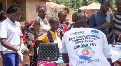 Concern vaccination team member records community members' information at a clinic