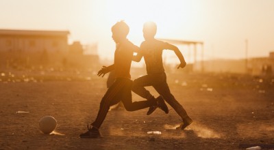 Two boys playing football