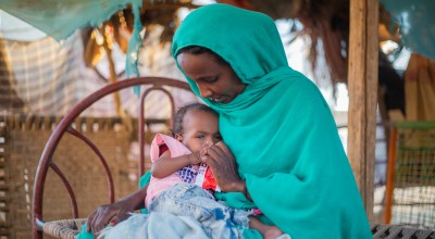 Malaz feeds her two-year-old Aida ready-to-use-therapeutic food at her home in Kassala State. During the mass mid-upper arm circumference (MUAC) screening and referral for children under five, Aida was confirmed severely malnourished. She was very weak and immediately referred to Al-Arab health facility for treatment. (Photo: Ahmed Elfatih Mohamdeen/UNICEF)