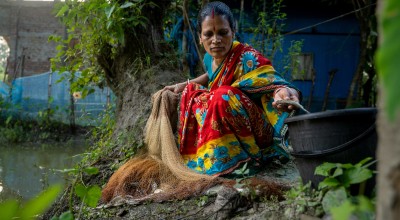 Shochi Ray sorts fish from her today’s catch, releasing the tiny ones back to the pond in Kalinagar, Kamarkhola. Photo: Mumit M/Concern Worldwide