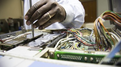 Engineers at Kenyatta Hospital in Nairobi work to repair broken medical equipment. Photo: Concern Worldwide. 